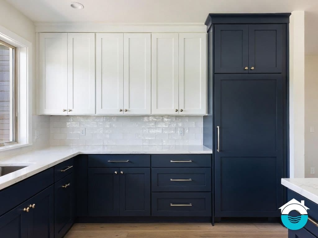Illustration of a two-tone kitchen with navy lower cabinets, white uppers and a white tile backsplash